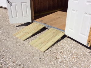 Storage shed with ramps for golf carts